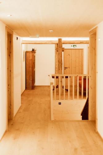 an empty room with a wooden floor and a door at Gasthof Adler in Doren
