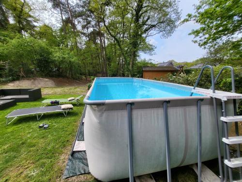 a swimming pool in a yard with a boat at Seychellen House in Großenkneten