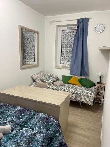 a bedroom with two beds and a window at Greta family house in Rome