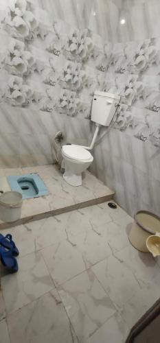 a bathroom with a toilet in a room at Ganga niwas in Prayagraj