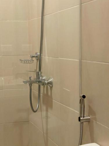 a shower in a bathroom with a glass door at Opulent Spacious 3 BR Condominium at St Dominique at Megaworld in Iloilo City