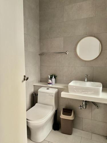 a bathroom with a toilet and a sink at The Shore Kota Kinabalu by Daisy Suites in Kota Kinabalu