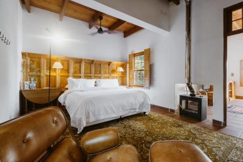 a large bedroom with a bed and a fireplace at De Bergkant in Prince Albert