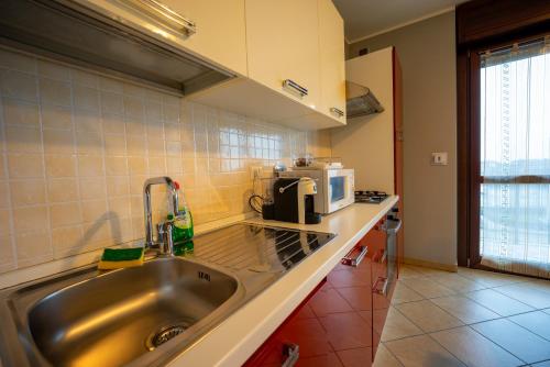 a kitchen with a sink and a microwave at Turin Airport premium apartment G in Leinì
