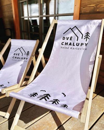 a sign sitting on a chair with a towel on it at Dvě chalupy - Velké Karlovice in Velké Karlovice