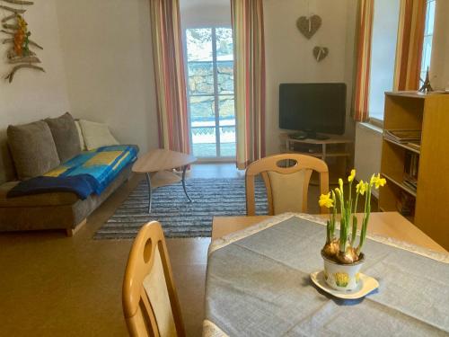 a living room with a table and a couch at Appartement Johanna in Schwarzenberg am Bohmerwald