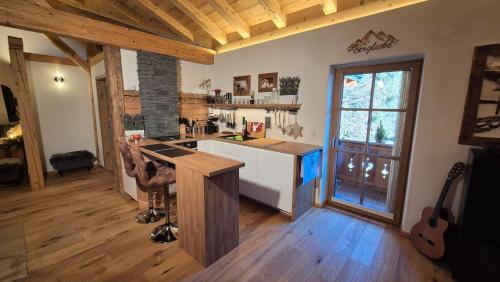 a kitchen with a counter top in a room with guitars at das historische MEIXNER am Rerobichl Bezirk Kitzbühel in Oberndorf in Tirol