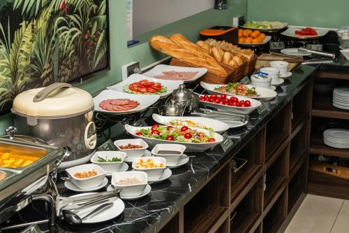 a buffet with plates of food on a table at Nature Hotel in Hanoi