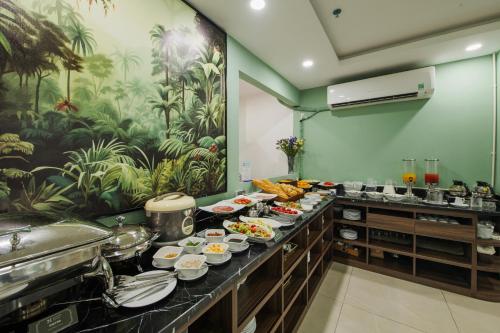 a buffet in a hotel room with plates of food at Nature Hotel in Hanoi