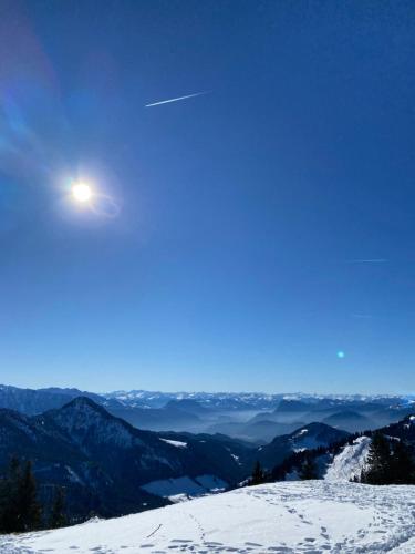 a view of a snow covered mountain with the moon at Ferienhaus Westerbuchberg in Übersee