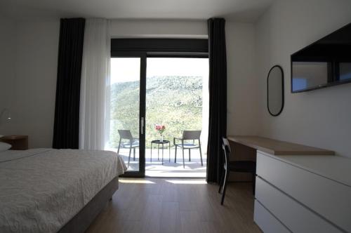 a bedroom with a bed and a table and chairs at Luxury Villa Mandy - Split in Žrnovnica