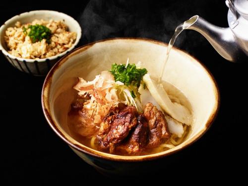 a bowl of food with meat and onions and rice at Southwest Grand Hotel in Naha