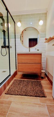a bathroom with a sink and a mirror at Gîte 4 personnes avec piscine et bain nordique proche des plages du débarquement in Le Manoir
