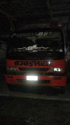 a truck is parked in a garage at night at ramfels car rental ,travel and tour in Siluton