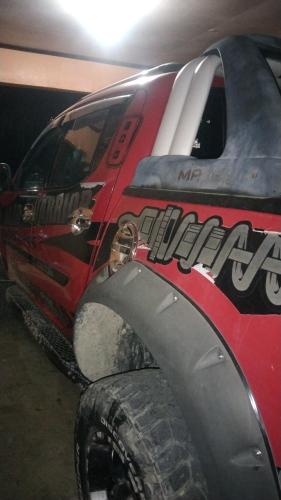 a red monster truck with a large tire at ramfels car rental ,travel and tour in Siluton
