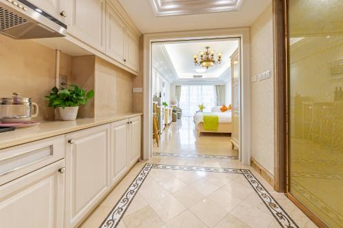 a kitchen with a door leading to a bedroom at WAIFIDEN Guangzhou HaiZhu Square WanYi Apartment in Guangzhou