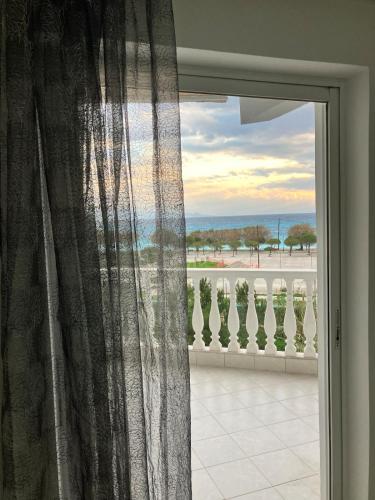 a window with a view of the ocean at Seasmiles2 in Paralía Akrátas