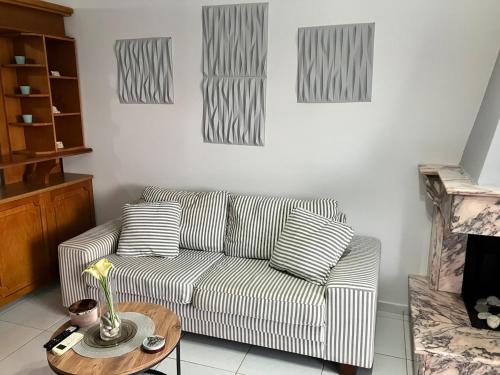 a living room with a couch and a table at Seasmiles2 in Paralía Akrátas