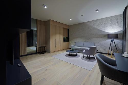 a living room with a couch and a table at Ilonn Boutique Limanowskiego in Poznań