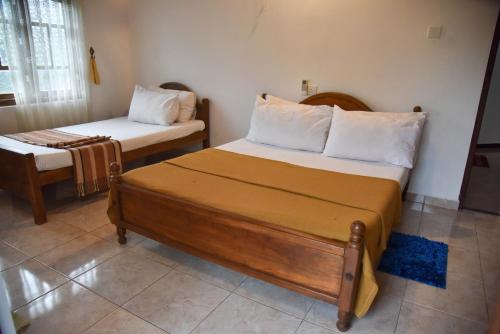 En eller flere senge i et værelse på Urumaya Resort & Eco Farm