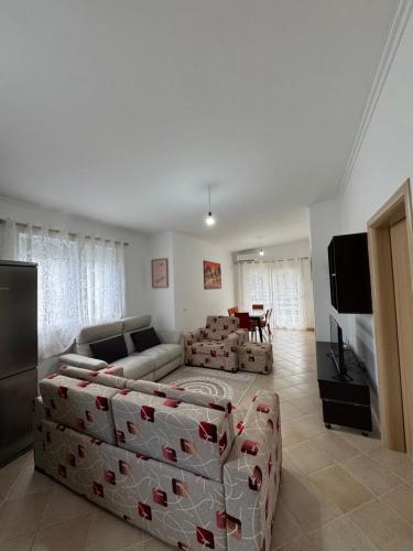 a living room with a couch and a table at Machiavelli Apartments Lura 1 in Draçi