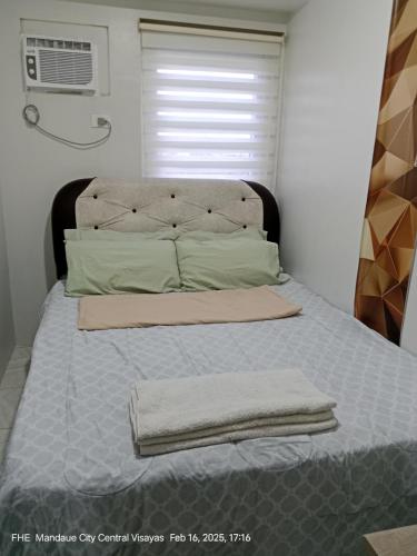 a bed with two towels on it in a bedroom at Lloyds Barato 2BR Condo Unit 6paxMax in Mandaue City