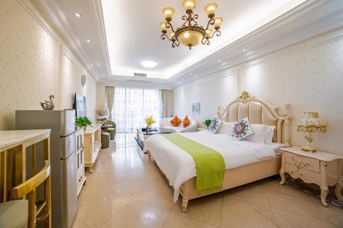 a bedroom with a large bed and a chandelier at WAIFIDEN Guangzhou HaiZhu Square WanYi Apartment in Guangzhou