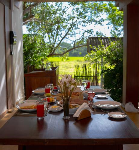 a wooden table with plates of food on it at Tribe Wilpattu - Eco Lodge in Wilpattu