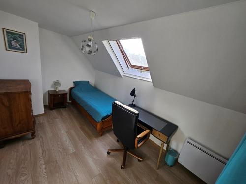 a bedroom with a desk and a bed and a window at Spacious Room for Rent in Le Pecq in Le Pecq