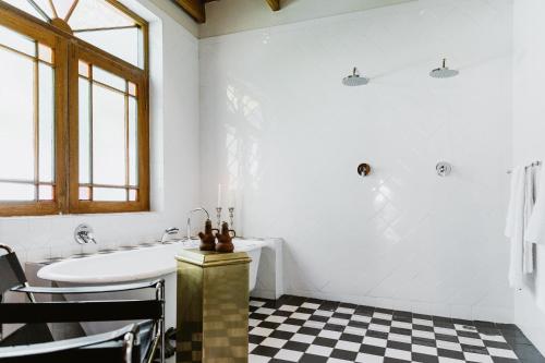a bathroom with a white tub and a sink at De Bergkant in Prince Albert