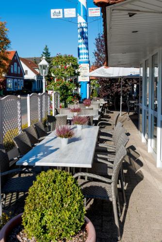 a table and chairs sitting on a patio at Landhotel Butjadinger Tor in Nordenham