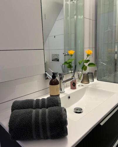 a bathroom sink with a black towel on it at Top apartment with a view in Tromsø