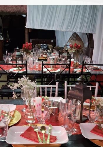 a table with plates and glasses on top at Theza's Place in Johannesburg