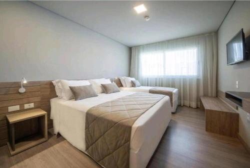 Postel nebo postele na pokoji v ubytování Laghetto Golden Gramado Resort
