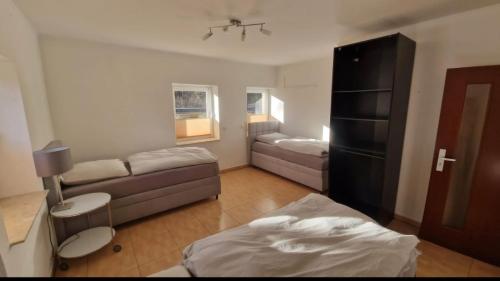 a small living room with a couch and a bed at Zimmer am See mit Zugang in Zeuthen