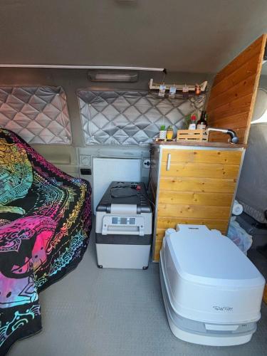 an interior of an rv with a stove and a bed at Furgoneta camperizada para dormir y conducir in Arona