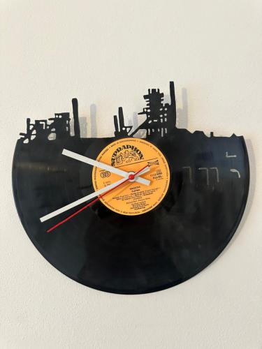 a black and orange clock on a wall at Penzio Ostrava in Ostrava