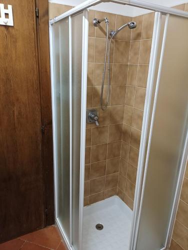 a shower with a glass enclosure in a bathroom at Blue Lake House in Iseo