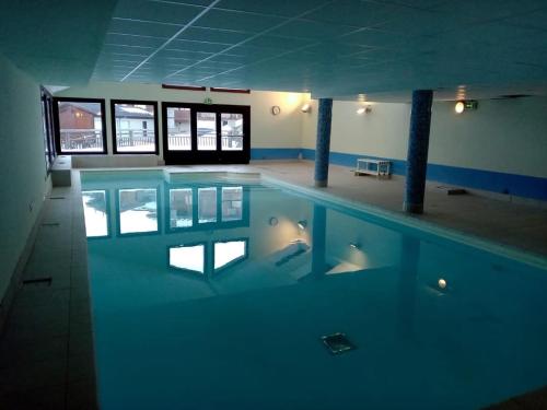 une piscine vide avec sa réflexion dans l'eau dans l'établissement Chalets des Evettes- appartement vue montagne, à Flumet