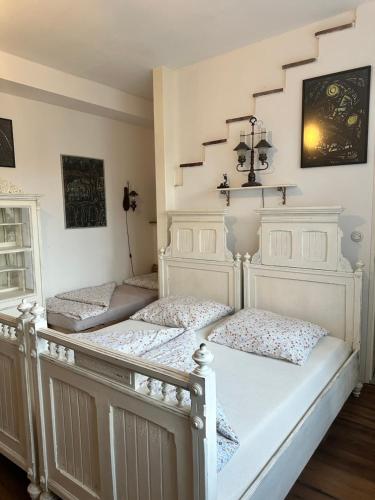 two twin beds in a room with white walls at Penzio Ostrava in Ostrava
