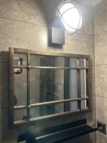 a bathroom mirror with a light above a sink at Penzio Ostrava in Ostrava