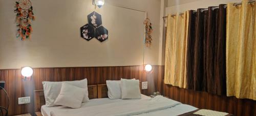a bedroom with a bed and a clock on the wall at The Lake & woods in Bhīm Tāl