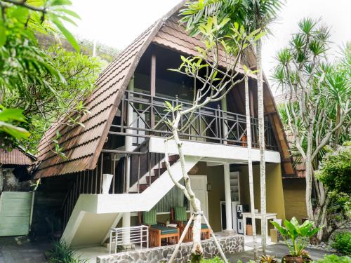 a house with a staircase leading up to it at Peneeda View Beach Hotel in Sanur