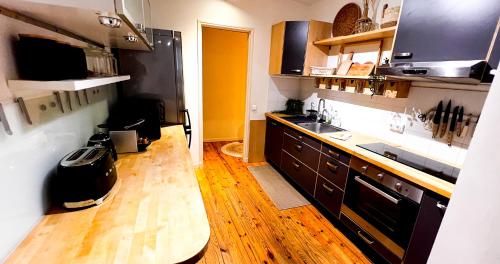 a kitchen with a sink and a wooden floor at Hypercenter - Wifi - In the heart of Avignon! in Avignon