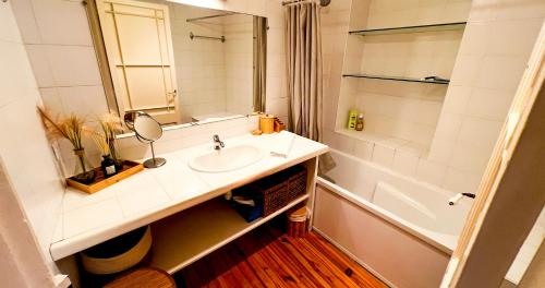 a bathroom with a sink and a mirror and a tub at Hypercenter - Wifi - In the heart of Avignon! in Avignon