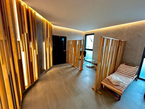 a room with wooden walls and a bench in it at Hotel GOLD JET Bihać in Bihać
