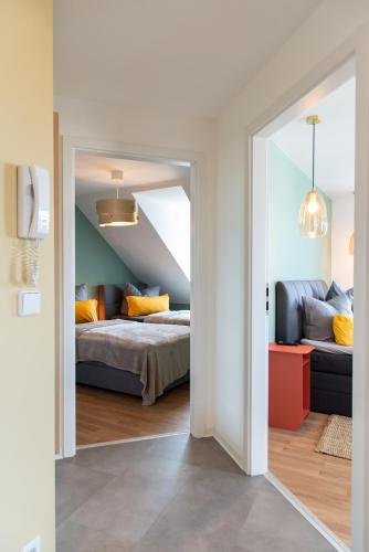 a room with two beds and a room with an attic at Bauhaus Apartment - Netflix, Nespresso, Zentral, Messe in Chemnitz