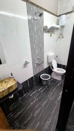 a dirty bathroom with a toilet and a sink at Raghunandan Resort Cottages in Nashik