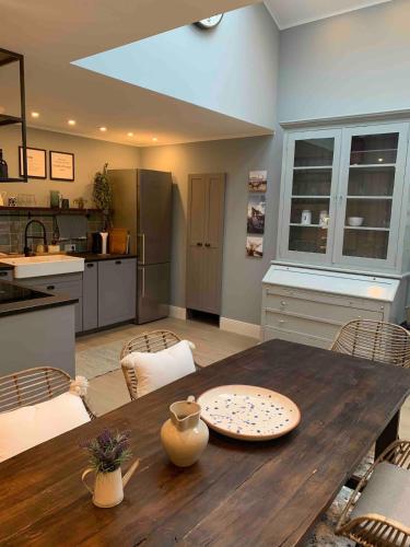 a kitchen and dining room with a wooden table at Designer loft with terrace in Neuss