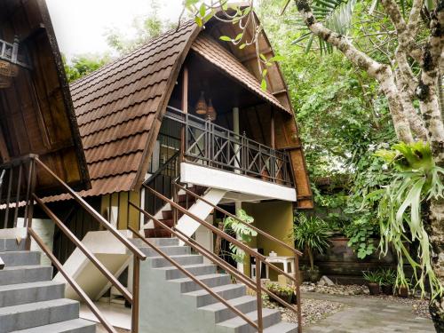 a house with stairs leading up to it at Peneeda View Beach Hotel in Sanur